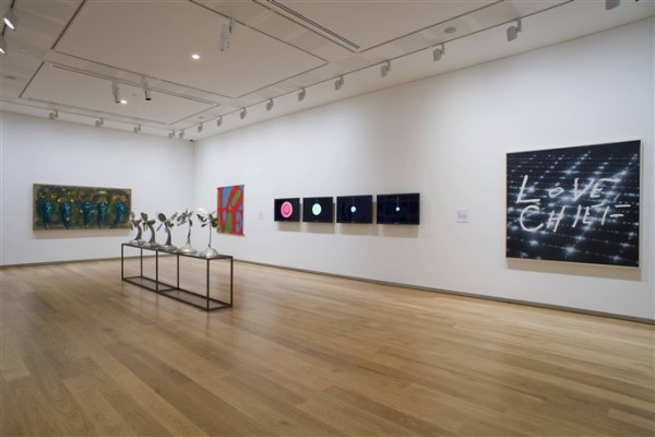 Artworks hanging on the wall in one of the second floor gallery spaces at Auckland Art Gallery. In the centre of the right hand wall, four television screens play Daniel von Sturmer's work Painted Video, in which wet paint in different bright colours is poured onto a black surface. Three works of different sizes are hung next to von Sturmer's work, and in the centre of the room is an installation of several silver plant forms on a metal rectangular structure.